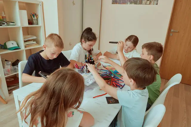 Children drawing and crafting together at a table