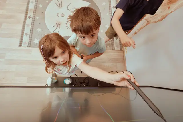 Children drawing on an interactive touch screen